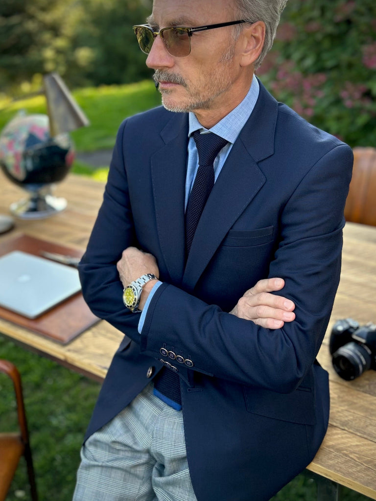 Photo of a man wearing a classic midnight navy blazer.