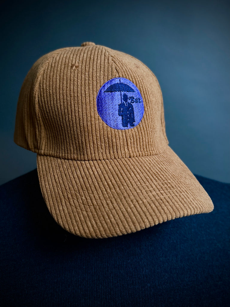 Corduroy Baseball Cap. Tobacco/Lilac Logo.
