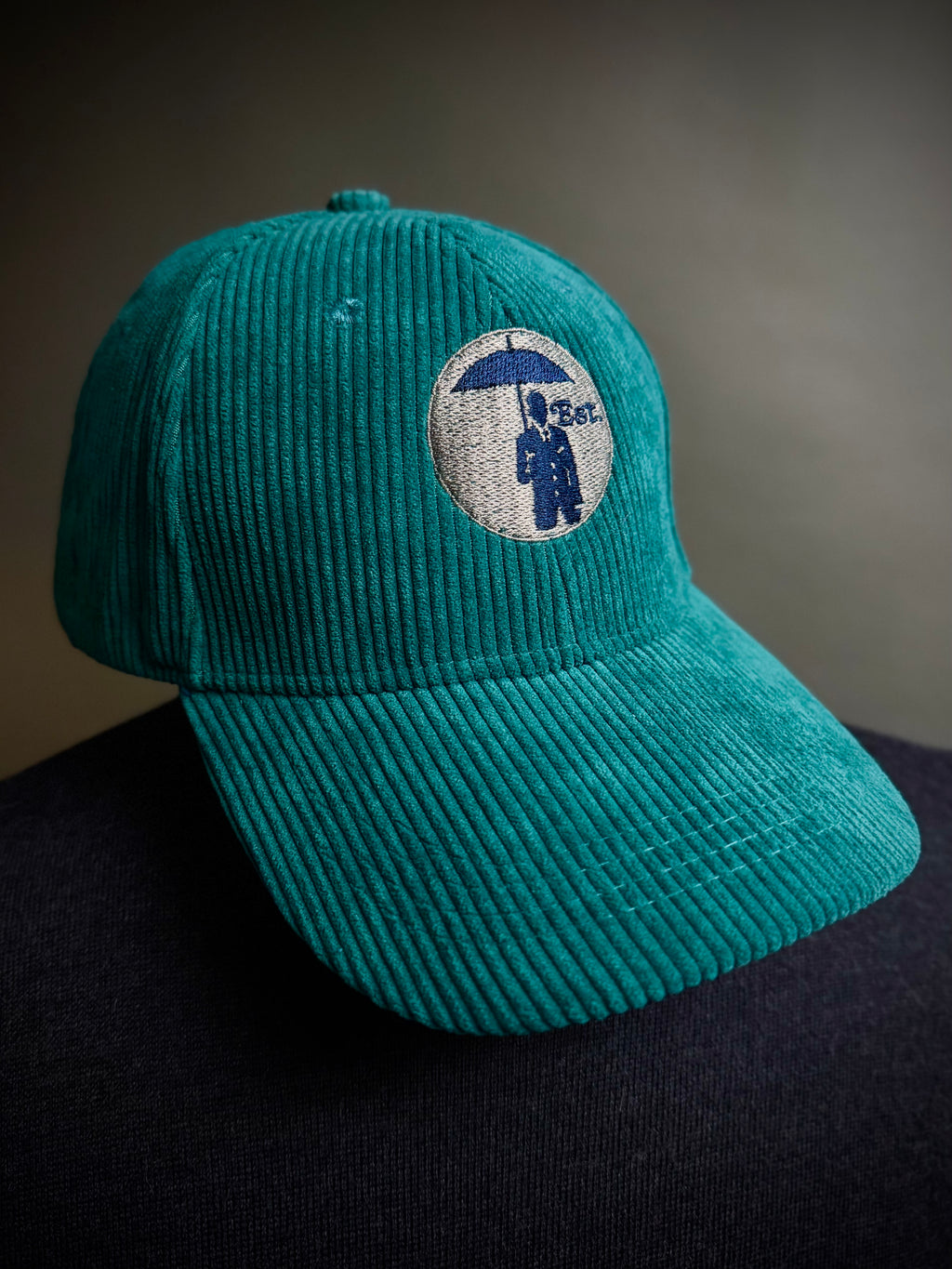 Corduroy Baseball Cap. Dark Teal/Grey Logo.