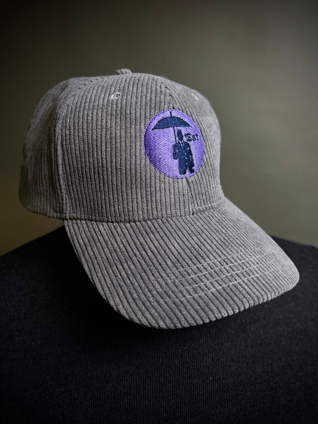 Corduroy Baseball Cap. Grey/Lilac Logo.