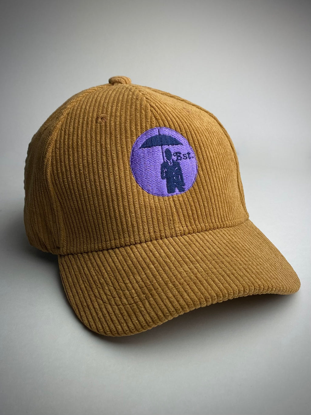 Corduroy Baseball Cap. Tobacco/Lilac Logo.